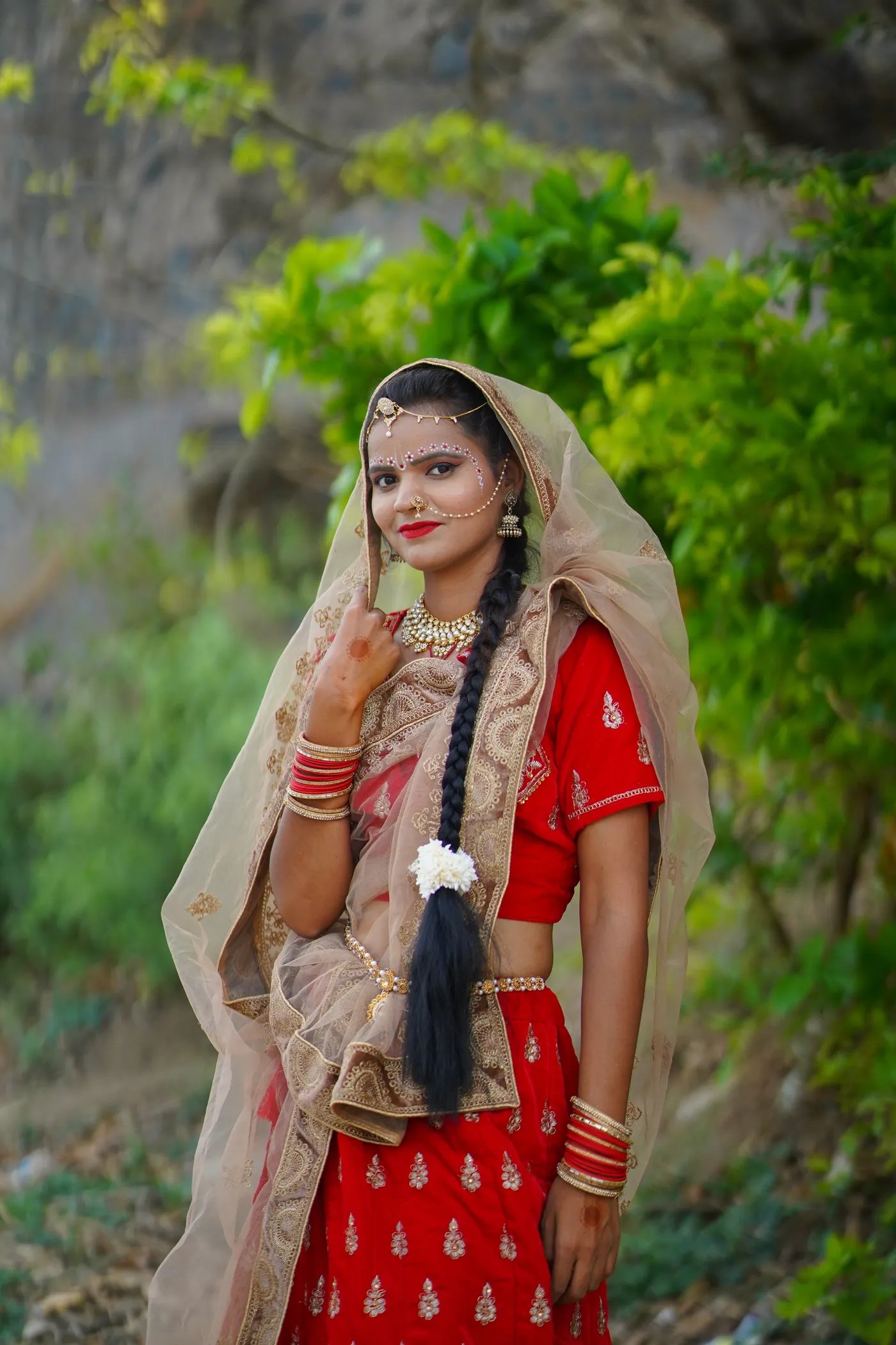 Crimson bridal lehenga with gold embroidery, shown whole